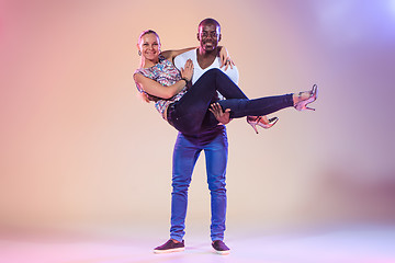 Image showing Young couple dances social Caribbean Salsa, studio shot 