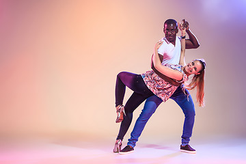 Image showing Young couple dances social Caribbean Salsa, studio shot 