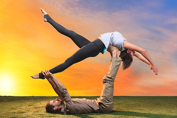 Image showing The two people doing yoga exercises 