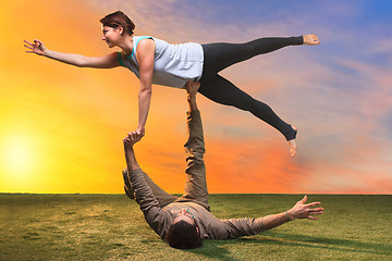 Image showing The two people doing yoga exercises 