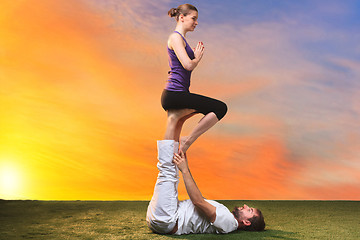 Image showing The two people doing yoga exercises 