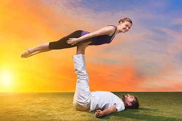 Image showing The two people doing yoga exercises 