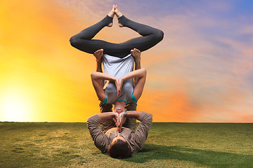 Image showing The two people doing yoga exercises 