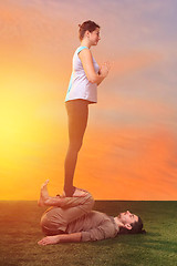 Image showing The two people doing yoga exercises 