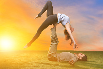 Image showing The two people doing yoga exercises 