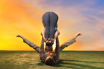 Image showing The two people doing yoga exercises 