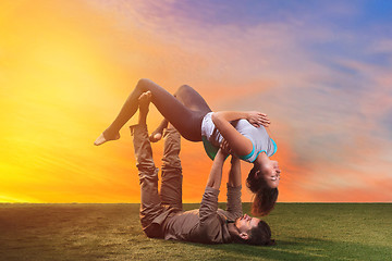 Image showing The two people doing yoga exercises 