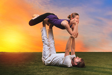 Image showing The two people doing yoga exercises 