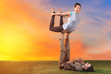 Image showing The two people doing yoga exercises 