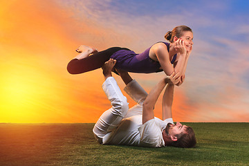 Image showing The two people doing yoga exercises 