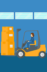 Image showing Warehouse worker moving load by forklift truck.