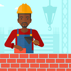 Image showing Bricklayer with spatula and brick.