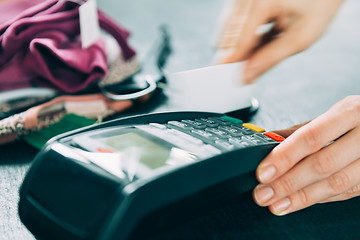 Image showing hand swiping credit card in store