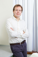 Image showing Young man with confident smile and arms folded