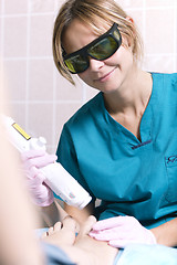 Image showing Smiling practitioner doing a laser treatment