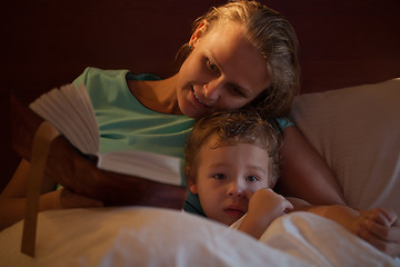 Image showing Mother reading a bedtime story to her little son