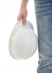 Image showing Male engineer in jeans holding white hardhat