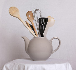 Image showing Old teapot filled with spoons