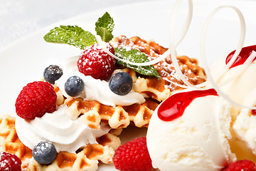 Image showing Waffle with vanilla ice cream and fresh berries