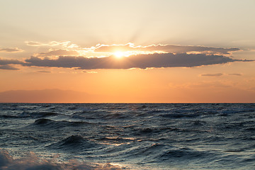 Image showing Rough sea and sunset over it