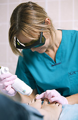Image showing Doctor doing a laser treatment on womans foot