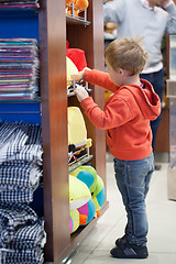 Image showing Cute little boy shopping for a beach accessories