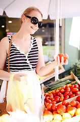 Image showing Young woman shopping for fresh tomatoes