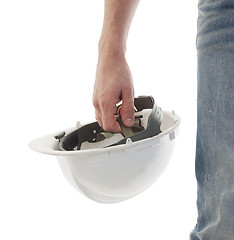 Image showing Male engineer in jeans holding white hardhat