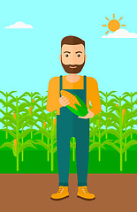 Image showing Farmer holding corn.