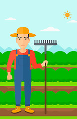 Image showing Farmer with rake.