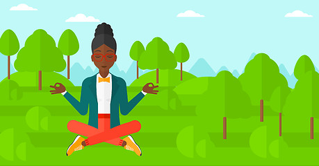 Image showing Business woman meditating in lotus pose.