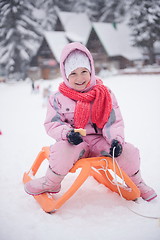 Image showing little girl sitting on sledges