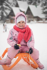 Image showing little girl sitting on sledges
