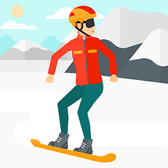 Image showing Young woman snowboarding.