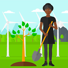 Image showing Woman plants tree.