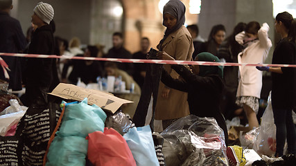 Image showing Syrian Refugees Listening to Announcement at Charity Collecting Point in Copenhagen Railroad Station