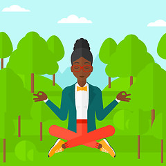 Image showing Business woman meditating in lotus pose.