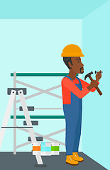 Image showing Constructor hammering nail.