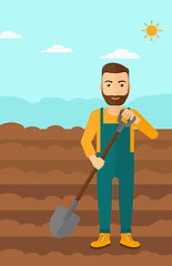 Image showing Farmer on the field with shovel.