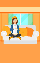 Image showing Pregnant woman sitting on sofa.