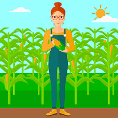 Image showing Farmer holding corn.