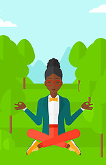 Image showing Business woman meditating in lotus pose.