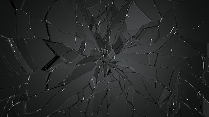 Image showing Pieces of splitted or cracking glass on black