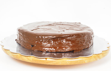 Image showing Sacher chocolate cake on a silver plate on wooden board towards 