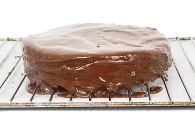 Image showing Chocolate icing dripping off from freshly made sacher torte cake