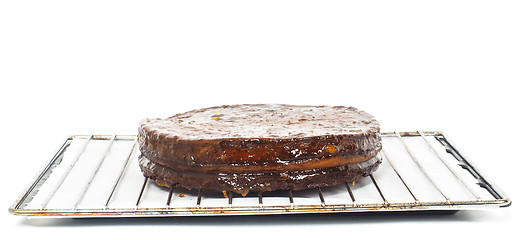 Image showing Half stage on sacher torte chocolate cake on grid before chocola
