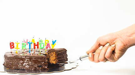 Image showing Female person serving a homemade sacher chocolate cake with birt