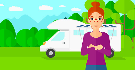 Image showing Woman standing in front of motor home.