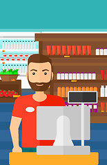 Image showing Salesman standing  at checkout.