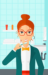 Image showing Woman brushing teeth.